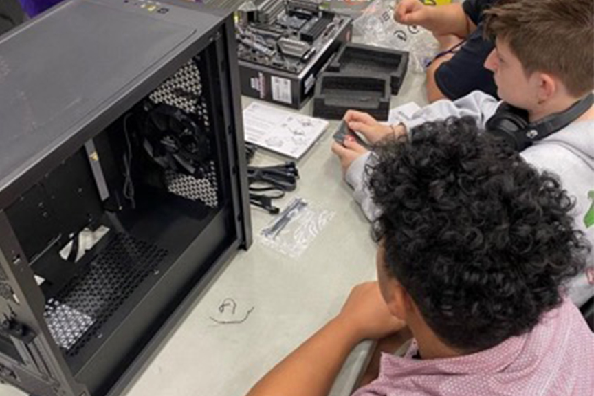 A couple of students fixing a computer