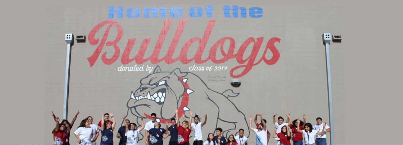 Students cheering under Home of the Bulldogs mural